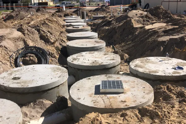 Concrete soak wells positioned in an excavated trench ready for installation